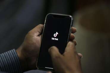 A man opens social media app ‘Tik Tok’ on his cell phone, in Islamabad, Pakistan, Tuesday, July 21, 2020. Pakistan has threatened the China-linked TikTok video service and blocked the Singapore-based Bigo Live streaming platform, citing what the regulating authority called widespread complaints about “immoral, obscene and vulgar” content. (AP Photo/Anjum Naveed)