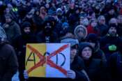 People gather as they protest against the AfD party and right-wing extremism in front of the Reichstag building in Berlin, Germany, Sunday, Jan. 21, 2024. (AP Photo/Ebrahim Noroozi)