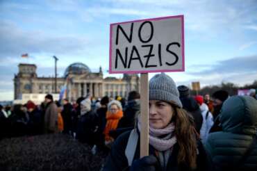 People gather as they protest against the AfD party and right-wing extremism in front of the Reichstag building in Berlin, Germany, Sunday, Jan. 21, 2024. (AP Photo/Ebrahim Noroozi)