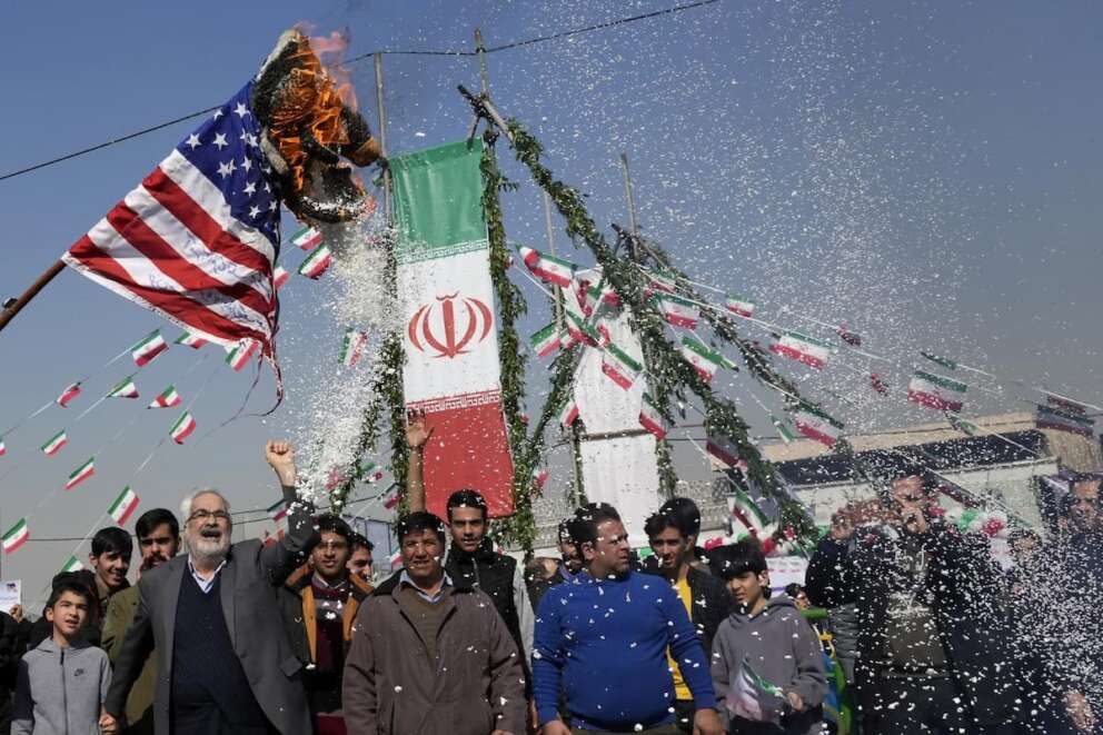 Demonstrators burn a U.S. flag during their annual rally commemorating Iran’s 1979 Islamic Revolution in Tehran, Iran, Sunday, Feb. 11, 2024. Iran marked Sunday the 45th anniversary of the 1979 Islamic Revolution amid tensions gripping the wider Middle East over Israel’s continued war on Hamas in the Gaza Strip. (AP Photo/Vahid Salemi)