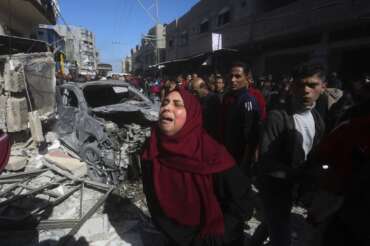 A Palestinian woman reacts after an Israeli strike on Shaheen family house in Rafah, Gaza Strip, Saturday, Feb. 24, 2024. (AP Photo/Hatem Ali)