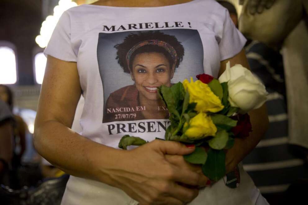 FILE – In this March 14, 2019 file photo, a woman wears a T-shirt designed with an image of slain councilwoman Marielle Franco during a memorial Mass to mark the one-year anniversary of her death, at the Candelaria Catholic Church in Rio de Janeiro, Brazil. A former military policeman being investigated for his possible involvement in the 2018 murder of Franco has been killed on Sunday, Feb. 9, 2020, by special police forces in Brazil’s northeastern state of Bahia. (AP Photo/Silvia Izquierdo, File)
