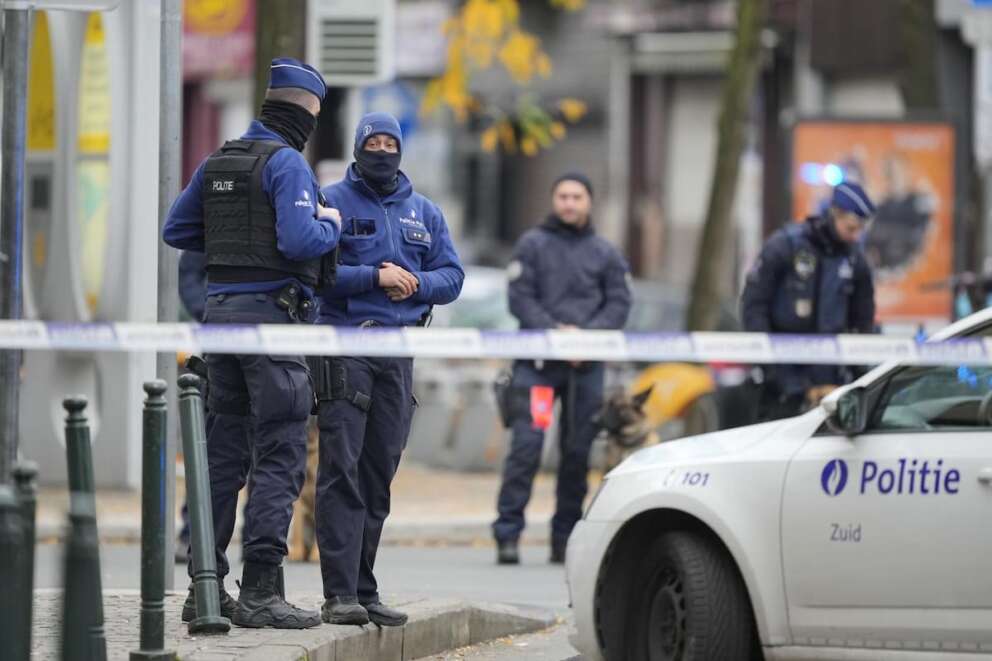 Belgian Police stand behind a cordoned off area close to where a suspected Tunisian extremist has been shot dead hours after manhunt looking for him Tuesday, Oct. 17, 2023. Police in Belgium have shot dead a suspected Tunisian extremist accused of killing two Swedish soccer fans in a brazen attack on a Brussels street before disappearing into the night on Monday. (AP Photo/Martin Meissner) Associated Press/LaPresse Only Italy and Spain