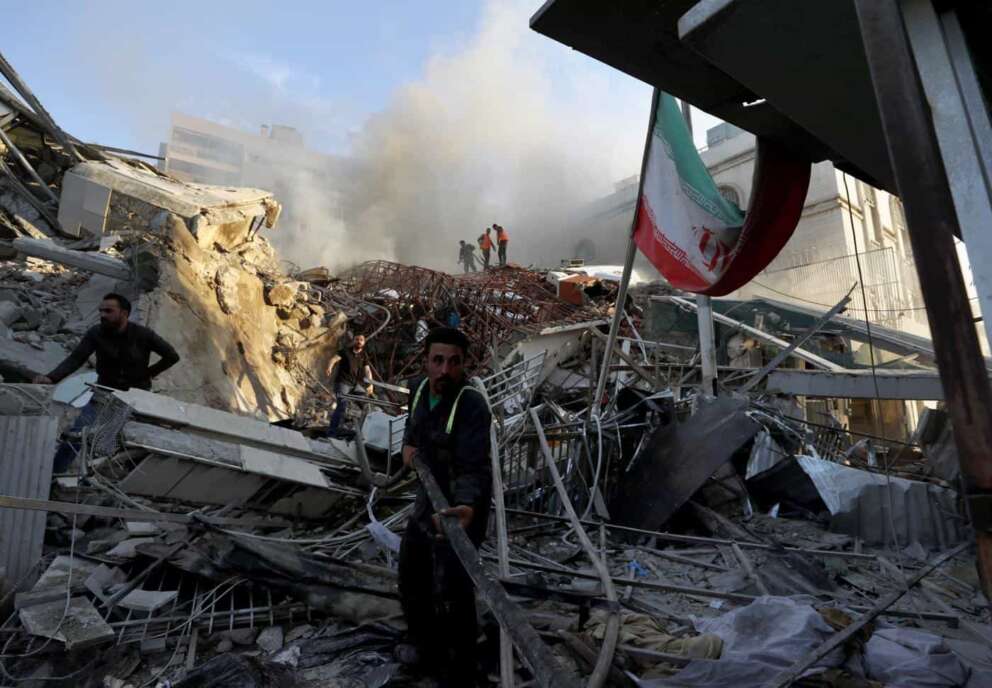 Emergency services work at a destroyed building hit by an air strike in Damascus, Syria, Monday, April 1, 2024. An Israeli airstrike has destroyed the consular section of Iran’s embassy in Damascus, killing or wounding everyone inside, Syrian state media said Monday. (AP Photo/Omar Sanadiki)
