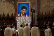 An image of 15-year-old Carlo Acutis, an Italian boy who died in 2006 of leukemia, is unveiled during his beatification ceremony celebrated by Cardinal Agostino Vallini in the St. Francis Basilica, in Assisi, Italy, Saturday, Oct. 10, 2020. (AP Photo/Gregorio Borgia)