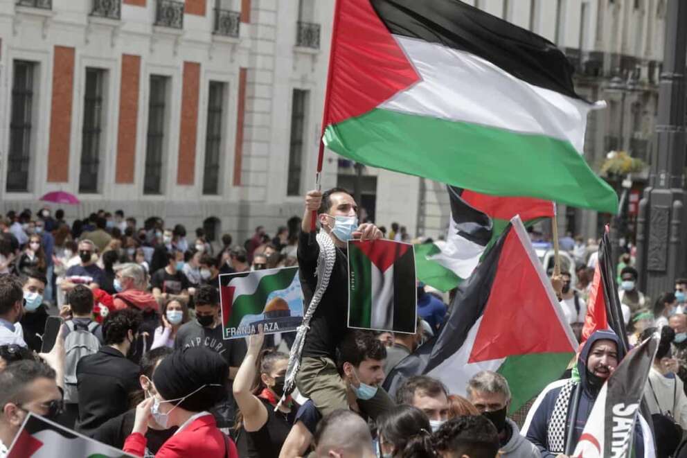 Protesters carry flags used to represent the State of Palestine and the Palestinian people as they march to protest against Israeli attacks on Palestinians in Gaza during a demonstration in Madrid, Spain, Saturday, May 15, 2021. (AP Photo/Paul White)
