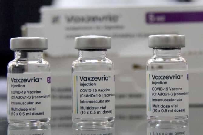 FILE – Vaxzevria COVID-19 vaccine, previously COVID-19 Vaccine AstraZeneca, are pictured at the Assad Iben El Fourat school in Oued Ellil, outside Tunis, on Aug.8, 2021. British-Swedish pharmaceutical company AstraZeneca said Friday that it will start to book a modest profit from its coronavirus vaccine as it moves away from the nonprofit model that it has operated so far during the pandemic. Through the pandemic so far, AstraZeneca said it would provide the vaccine, which was developed by scientists at the University of Oxford, “at cost.” It confirmed Friday that it will not be booking any coronavirus vaccine profits from developing countries. (AP Photo/Hassene Dridi)