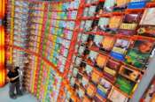 A staff member of a publishing house arranged thousands of books into a shelf at the Book Fair in Frankfurt, Germany, 05 October 2010. The world’s biggest fair for printed and digital books takes place from 06 October until 10 October 2010 and features more than 7000 exhibitors from 113 countries.The official opening of the Book Fair 2010 will take place on 5 October 2010. Photo: Boris Roessler