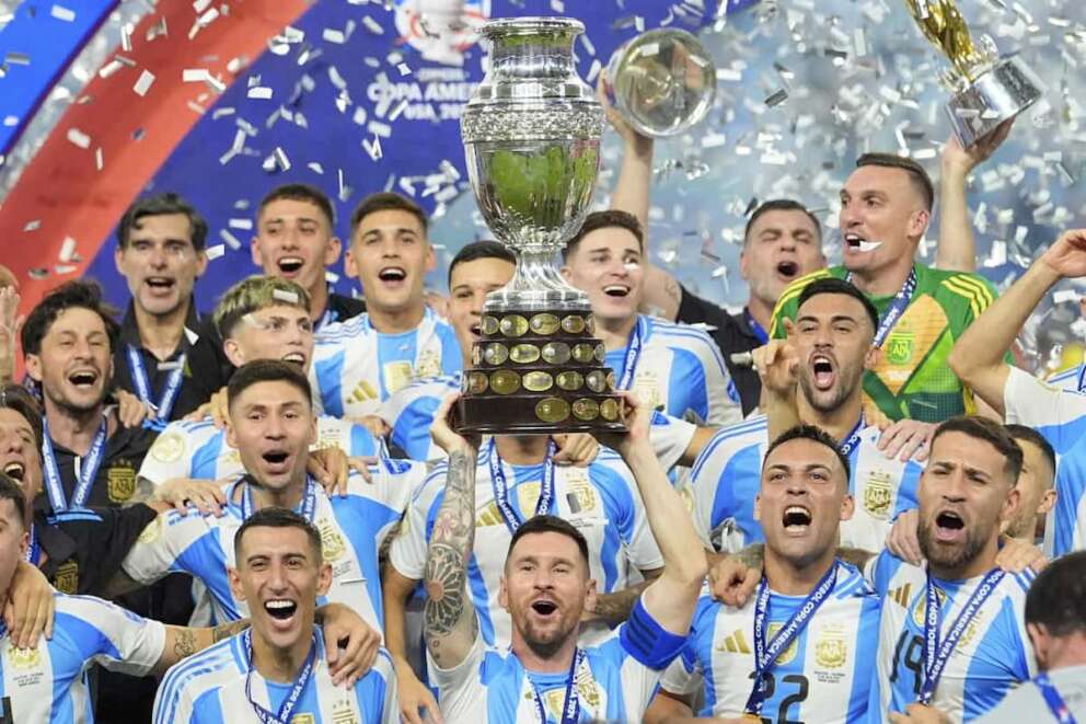 Lionel Messi hoists the trophy after Argentina defeated Colombia in the Copa America final soccer match in Miami Gardens, Fla., Monday, July 15, 2024. (AP Photo/Julio Cortez)