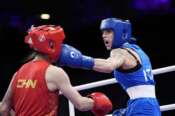 China’s Xu Zichun, left, fights Italy’s Irma Testa in their preliminary women’s 57kg boxing match at the 2024 Summer Olympics, Tuesday, July 30, 2024, in Paris, France. (AP Photo/John Locher)