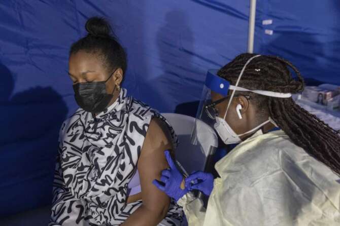 CORRECTS DATE TO TUESDAY AUG. 30, Morgan Ramey, 29, receives a dose of the monkeypox vaccine at a vaccinations site on Tuesday, Aug. 30, 2022, in the Brooklyn borough of New York. (AP Photo/Jeenah Moon)