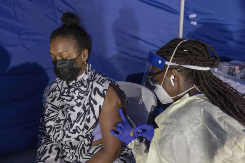 CORRECTS DATE TO TUESDAY AUG. 30, Morgan Ramey, 29, receives a dose of the monkeypox vaccine at a vaccinations site on Tuesday, Aug. 30, 2022, in the Brooklyn borough of New York. (AP Photo/Jeenah Moon)