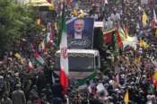 Iranians follow a truck, center, carrying the coffins of Hamas leader Ismail Haniyeh and his bodyguard who were killed in an assassination blamed on Israel on Wednesday, during their funeral ceremony at Enqelab-e-Eslami (Islamic Revolution) Sq. in Tehran, Iran, Thursday, Aug. 1, 2024. (AP Photo/Vahid Salemi)