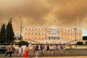 Smoke from wildfires is seen above the Greek parliament building in central Athens, Sunday, Aug. 11, 2024, after a blaze northeast of the capital forced evacuations in the area. (AP Photo/Derek Gatopoulos) Associated Press / LaPresse Only italy and Spain