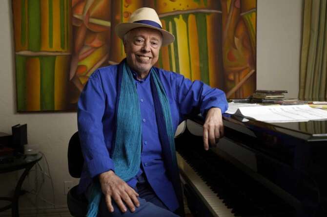 Brazilian musician Sergio Mendes poses for a portrait at home, Tuesday, May 18, 2021, in Los Angeles. The documentary “Sergio Mendes & Friends: A Celebration” will be airing on PBS in June. (AP Photo/Chris Pizzello)