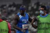 Oney Tapia of Italy prepares to compete with an assistant in the men’s shot put F11 final during the Tokyo 2020 Paralympics Games at the National Stadium in Tokyo, Japan, Monday, Aug. 30, 2021. (AP Photo/Eugene Hoshiko)