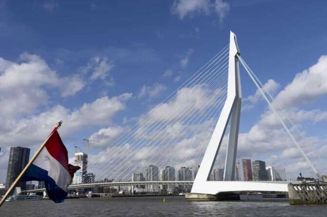 Erasmus bridge in Rotterdam, Netherlands, Wednesday, Feb. 23, 2022. The cable-stay bridge spanning Nieuwe Maas river links the northern and southern halves of the city with a 2,600-foot span in spectacular style. The bridge deck is supported by steel cables slung over a pylon that is bent to counter the forces of tension. Traffic passes underneath the 456-foot pylon as it straddles the roadway. The structure is called “the Swan” by locals because of its graceful posture over the water. (AP Photo/Peter Dejong)