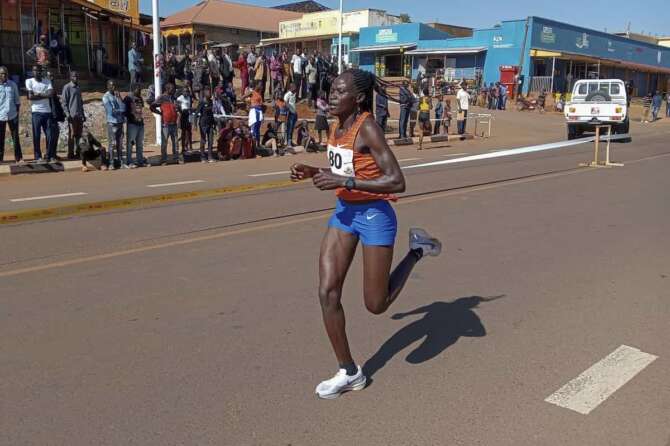 Rebecca Cheptegei, competes at the Discovery 10km road race in Kapchorwa, Uganda Friday, Jan. 20, 2023. A Cheptegei, a Ugandan athlete living in Kenya was set ablaze by her boyfriend on Sunday Sept. 1, 2024 and is currently receiving treatment for 75% burns, police said. (AP Photo)