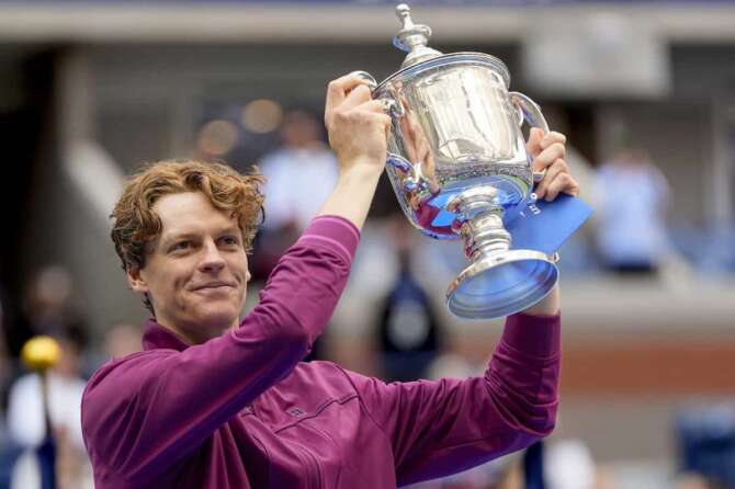 Jannik Sinner, of Italy, holds up the championship trophy after defeating Taylor Fritz, of the United States, in the men’s singles final of the U.S. Open tennis championships, Sunday, Sept. 8, 2024, in New York. (AP Photo/Julia Nikhinson)