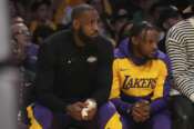 Los Angeles Lakers forward LeBron James guard Bronny James watch play during the first half of an NBA basketball game against the Minnesota Timberwolves, Tuesday, Oct. 22, 2024, in Los Angeles. (AP Photo/Eric Thayer) Associated Press/LaPresse