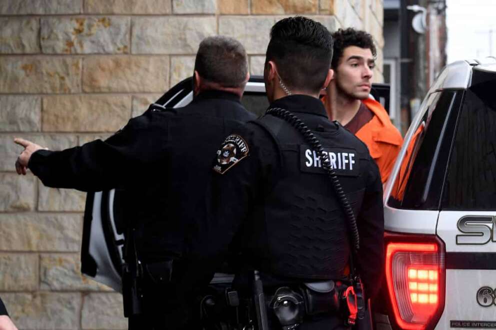 Luigi Nicholas Mangione is escorted into Blair County Courthouse, Tuesday, Dec. 10, 2024, in Hollidaysburg, Pa. (AP Photo/Gary M. Baranec)