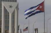 Cuban and American flags fly in the wind outside the American embassy in Havana, Cuba, Tuesday, Jan.14, 2025. (AP Photo/Ariel Ley)