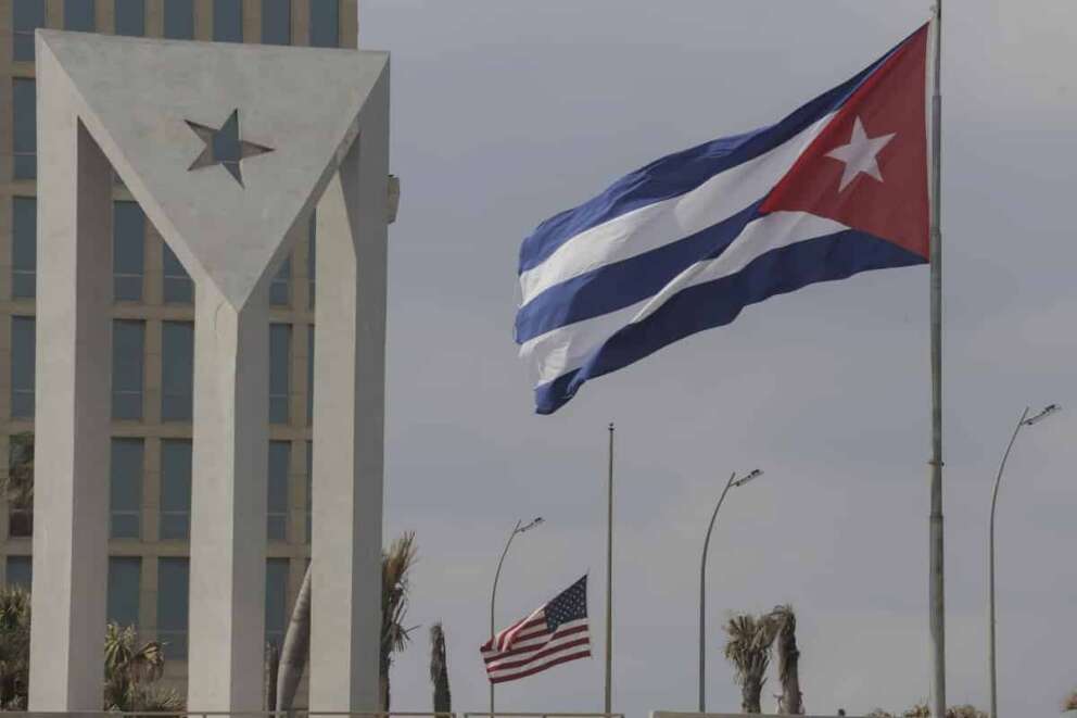 Cuban and American flags fly in the wind outside the American embassy in Havana, Cuba, Tuesday, Jan.14, 2025. (AP Photo/Ariel Ley)